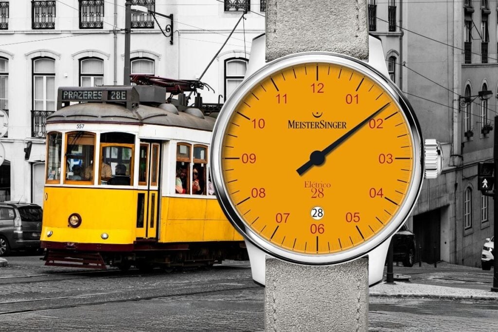 O amarelo está em destaque no novo relógio, numa alusão à cor do Elétrico 28. Às 6 horas, encontra-se a janela da data e tanto as horas como os minutos são indicados por meio de um único ponteiro central | Foto: MeisterSinger